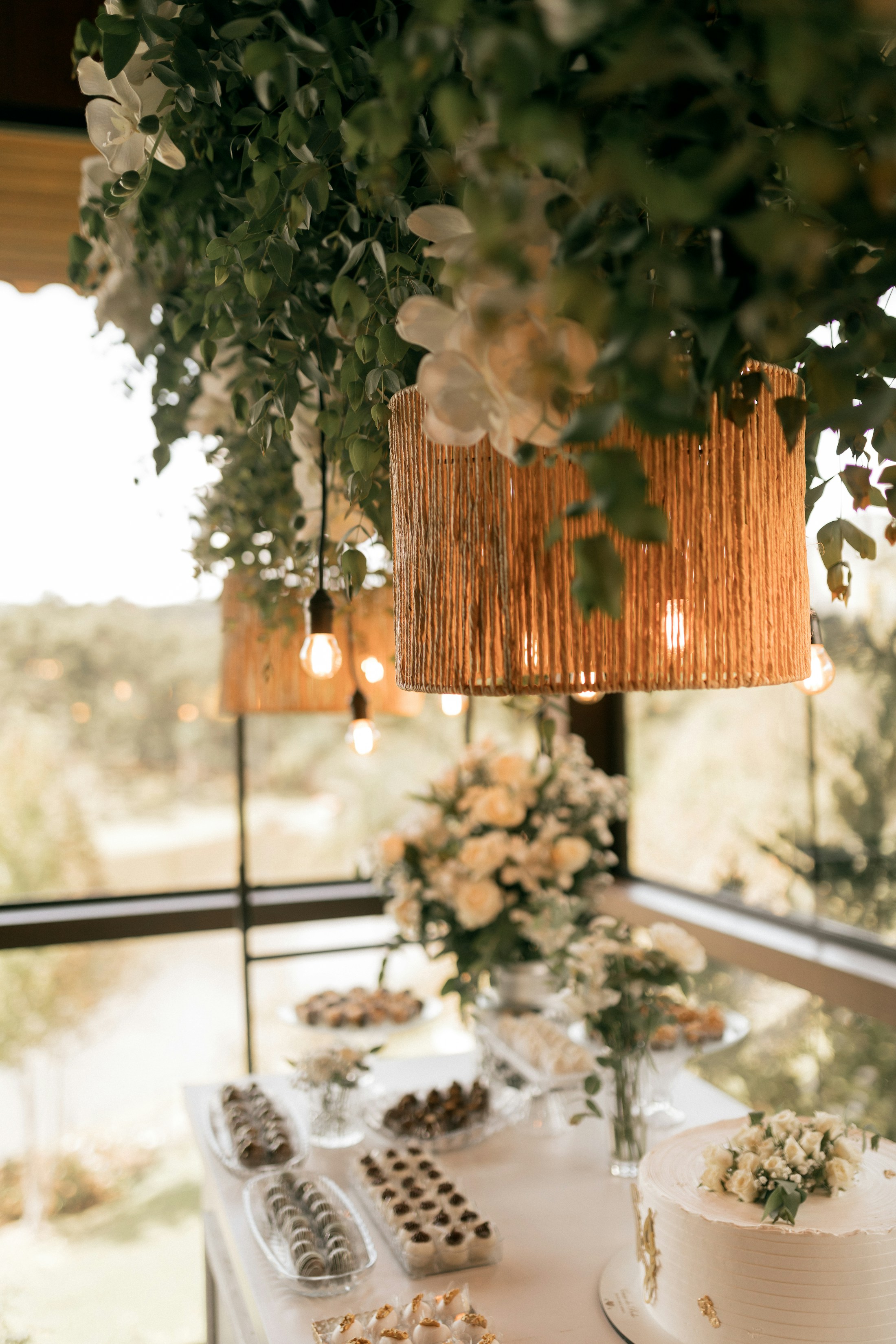 Dessert table with cake, cookies and floral styling